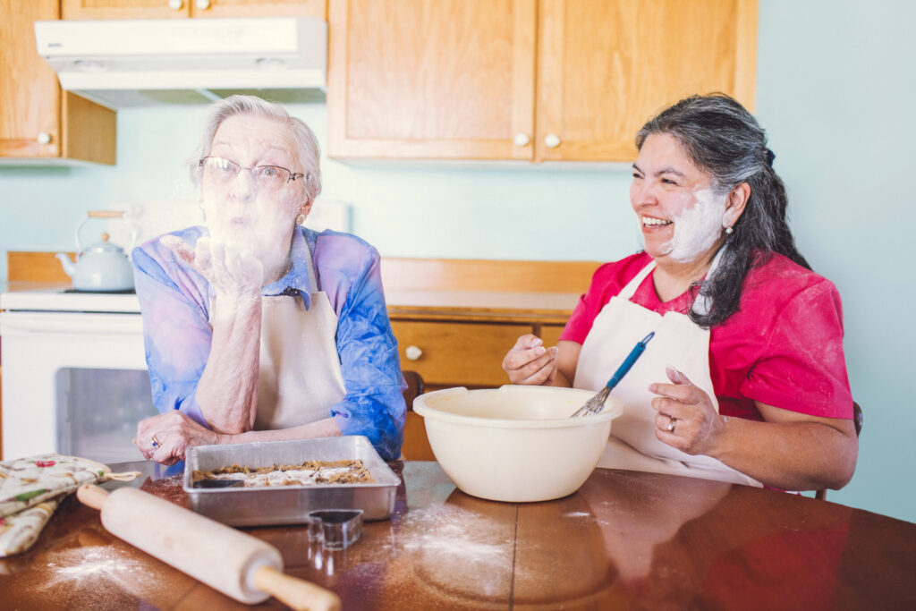 Nurse Next Door caregiver and client baking